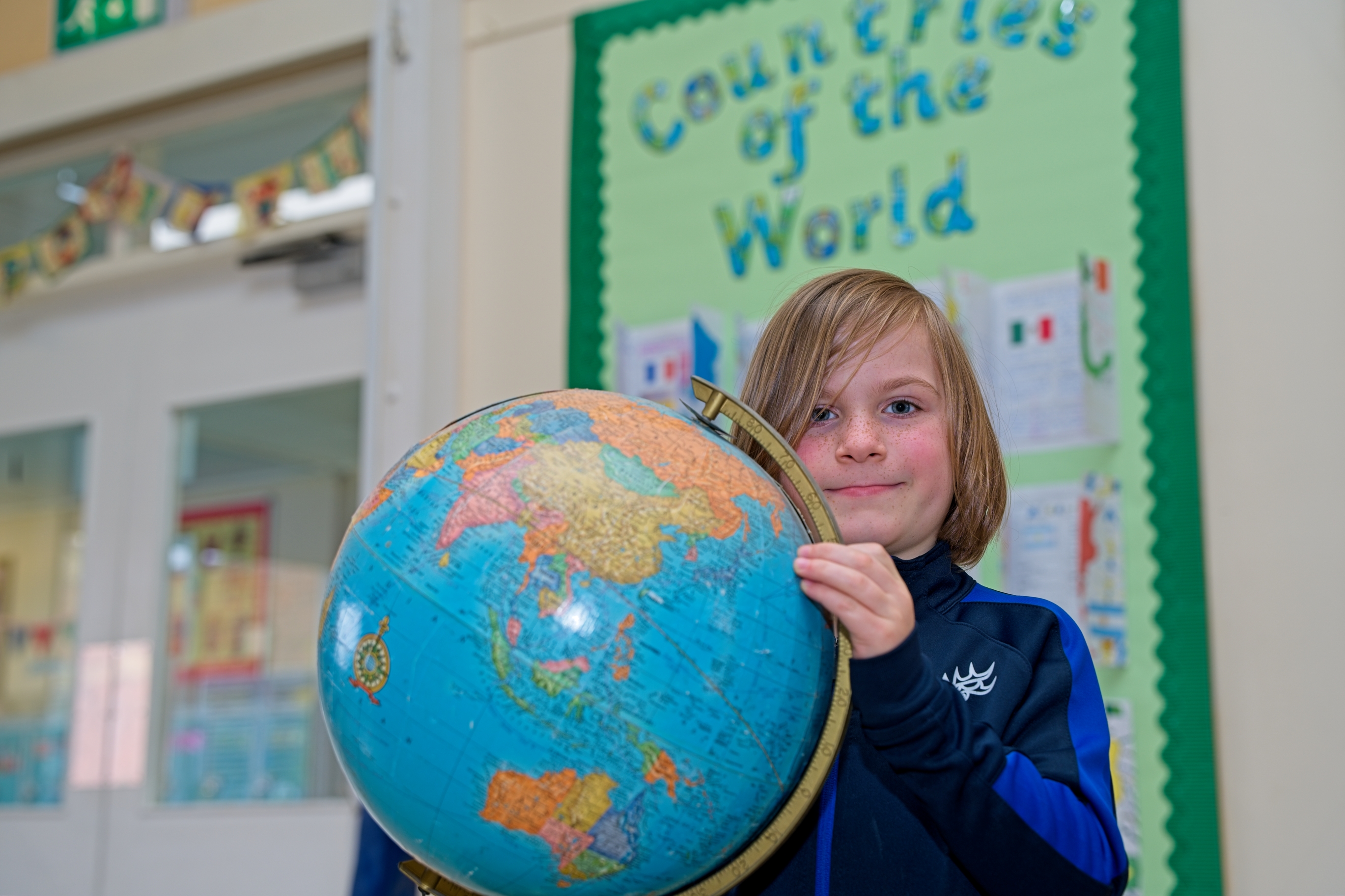 Pupil holding a globe.