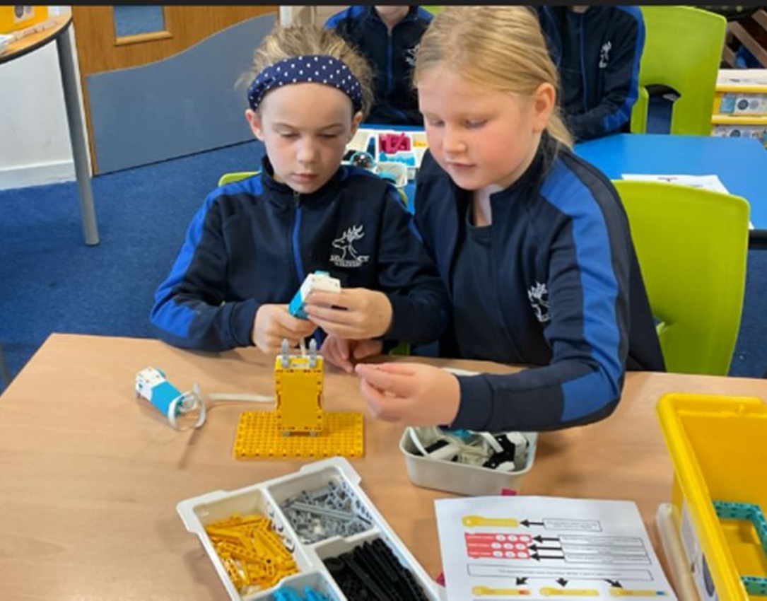 Y4 children enjoying their robotics workshop.