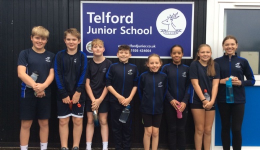 Indoor rowing team photographed in front of the school.