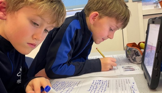 Picture of pupils using iPads for research.